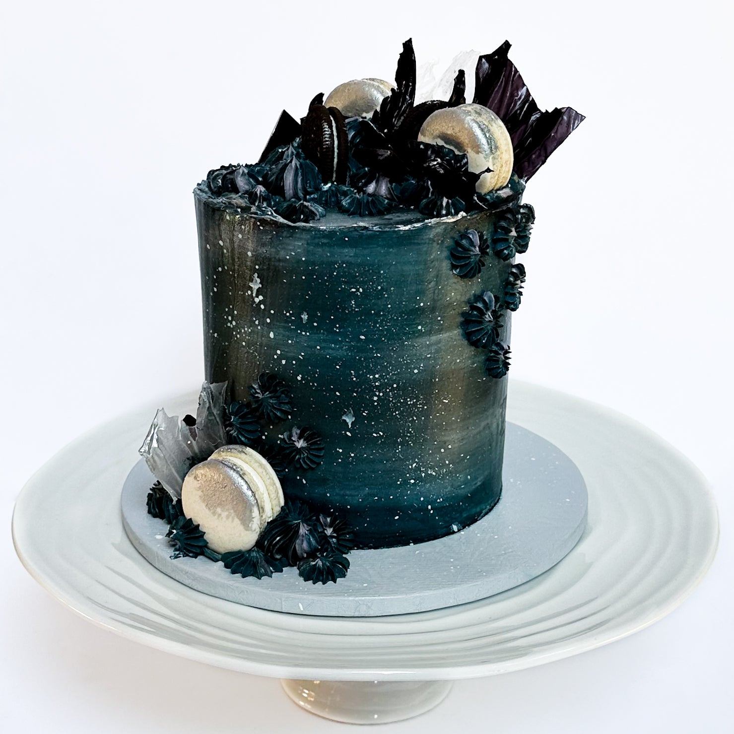 Galaxy themed cake with stars, macarons and biscuits